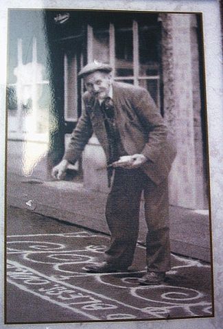 Image:Man Sanding the street in Knutsfrod for May Day 1920.jpg