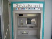 An ATM in the Netherlands.  The logos of a number of interbank networks this ATM is connected to are shown.