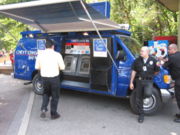 Security guards watching over ATMs that have been installed in a van.