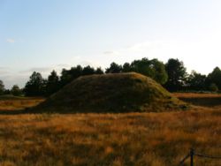 One of the Sutton Hoo burial mounds. This picture, taken during the Summer Solstice sunset on 21 June 2006, shows Mound 2 which is the only one of the Sutton Hoo mounds to have been reconstructed to its supposed original height. Alternate view.