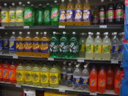 Soft drinks on supermarket shelves.