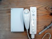 From left to right: Nintendo DS Lite, Nunchuk, Wii Remote and strap