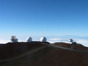 The Subaru Telescope (left) and Keck Observatory (center) on Mauna Kea, both examples of an observatory that operates at near-infrared and visible wavelengths. The NASA Infrared Telescope Facility (right) is an example of a telescope that operates only at near-infrared wavelengths.
