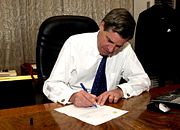 Coalition Provisional Authority director L. Paul Bremer signs over sovereignty to the appointed Iraqi Interim Government, June 28, 2004.