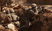 U.S. soldiers take cover during a firefight with insurgents in the Al Doura section of Baghdad March 7, 2007