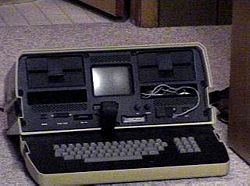 An opened Osborne 1 computer, ready for use. The keyboard sits on the inside of the lid.