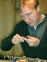 Oboist Albrecht Mayer preparing reeds for use.  Oboists scrape their own reeds to achieve the desired tone and response.