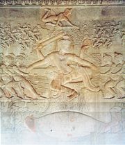 The bas-relief of the Churning of the Sea of Milk shows Vishnu in the centre, his turtle avatar Kurma below, asuras and devas to left and right, and apsaras and Indra above, from Ankor Wat