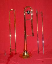 A disassembled trombone. From left to right: Mouthpiece, Outer Slide, Bell Section, Inner Slide.