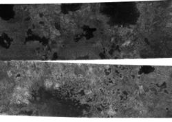 A photograph of Titan's northern latitudes.  The dark features appear to be hydrocarbon lakes, but further images will be needed to see if the dark spots remain the same (as they would if they were lakes)
