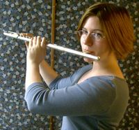 Playing a transverse flute.