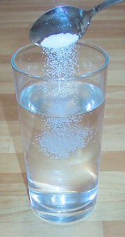 Making a saline water solution by dissolving table salt (NaCl) in water