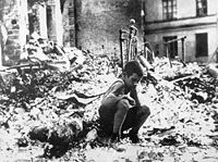 Survivor of bombing of Warsaw in the ruins of his home.