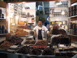 Many Muslims traditionally break their fasts in Ramadan with dates (like those offered by this date seller in Kuwait City), as was the recorded practice (Sunnah) of Muhammad.