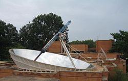 The Solar Bowl above the Solar Kitchen in Auroville, India concentrates sunlight on a movable receiver to produce steam for cooking.