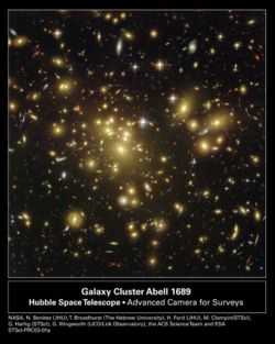Strong gravitational lensing as observed by the Hubble Space Telescope in Abell 1689 indicates the presence of dark matter - Enlarge the image to see the lensing arcs. Credits: NASA/ESA