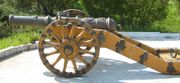 A small, cast-iron field cannon.