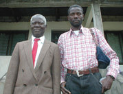 Two men in Kinshasa. The younger mans clothing recalls Billism