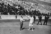 Schuhmann (left) and Georgios Tsitas shake hands before the final match of the wrestling competition.