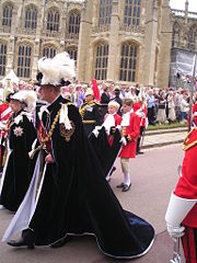 Queen Elizabeth II in the robes of the Sovereign of the Order, and the Duke of Edinburgh in the robes of a Royal Knight.