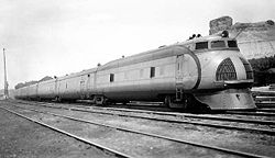 The M-10001 at Green River, Wyoming in 1937. The locomotive has been lengthened and given a 1,200 hp (890 kW) engine by this point; also, a more slanting pilot has been fitted and the paint scheme has been altered.