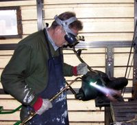 Gas welding a steel armature using the oxy-acetylene process.
