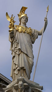 A neoclassical statue of Athena stands in front of the Austrian Parliament Building in Vienna.