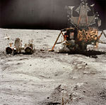 John Young works at the LRV near the Lunar Module Orion
