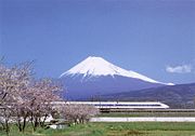 Japanese Shinkansen train passing Mount Fuji
