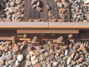 Bolted rail connection and tie-down. Also known as a fishplate.