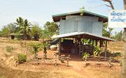 Isan houses are often built on stilts: the area underneath the house can be used as a living area, for storage or for keeping animals.  The large jar or ohng (โอ่ง) to the left of this house is used for storing water.