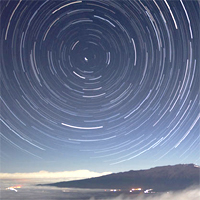 A time lapse photo showing the stars rotating around the celestial pole.