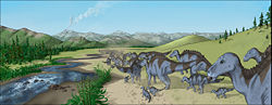 Illustration of a herd of Maiasaura walking along a creekbed, as found in the semi-arid Two Medicine Formation fossil bed. This region was characterized by volcanic ash layers and conifer, fern and horsetail vegetation.