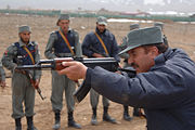 An Afghan National Police instructor using an AKS.