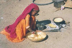 A girl from the Gadia Lohars nomadic tribe of Marwar, cooking on the outskirts of a village in Ratlam district