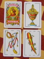 The four aces present in the baraja, from the deck made by Heraclio Fournier. Left to right, top to bottom: oros, copas, espadas, and bastos.