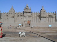 The Great Mosque's signature trio of minarets overlooks the central market of Djenné. Unique Malian aesthetic