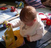 A child picking up a book.