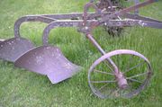 Horse-drawn, two-furrow plough.