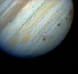 Brown spots mark impact sites on Jupiter's southern hemisphere.