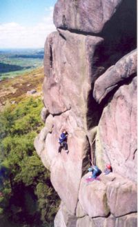 Rock climbers on Valkyrie at The Roaches in Staffordshire, England.