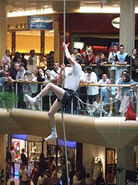 A competitor in a rope climbing event, at Lyon's Part-Dieu shopping centre.