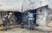 U.S. soldiers searching a village for NLF