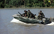Members of U.S. Navy SEAL Team One move down the Bassac River in a Seal team Assault Boat (STAB) during operations along the river south of Saigon, November 1967.
