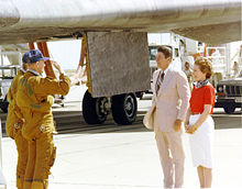 Columbia astronauts Thomas K. Mattingly and Pilot Henry W. Hartsfield salute President Ronald Reagan, standing beside his wife, Nancy, upon landing in 1982.