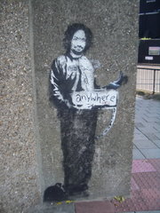 A stencil of Charles Manson in a prison suit, hitchhiking to anywhere, Archway, London