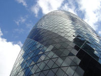 View of 30 St Mary Axe from street level. The building serves as the London headquarters for Swiss Re and is informally known as "The Gherkin".