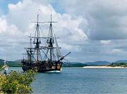 Lieutenant James Cook charted the east coast of Australia on HM Bark Endeavour, claiming the land for Great Britain in 1770. This replica was built in Fremantle in 1988; photographed in Cooktown Harbour where Cook spent seven weeks.