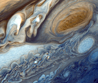 A false-color image of the Great Red Spot of Jupiter from Voyager 1. The white oval storm directly below the Great Red Spot has approximately the same diameter as the Earth. NASA image.