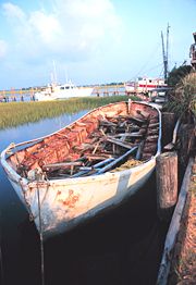 A ship's lifeboat, built of steel, rusting away in the wetlands of Folly Island, South Carolina, United States.